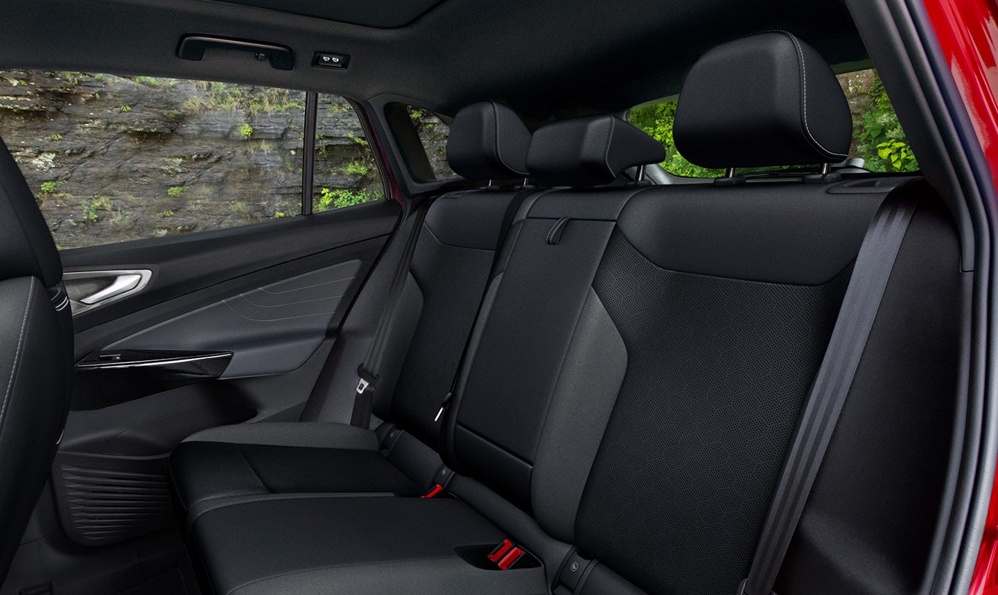 View looking in through the open, driver-side back door of an ID.4, onto an empty backseat, showing the 37.6 inches of leg room found in the rear seating area.